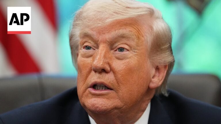 Close-up of Donald Trump speaking, with an AP logo in the top-left corner. The image focuses on his face with a blurred colorful background (news photo).