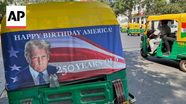 Green auto rickshaw with a patriotic banner showing a portrait of Donald Trump and the text 'HAPPY BIRTHDAY AMERICA! 250 YEARS OLD'.