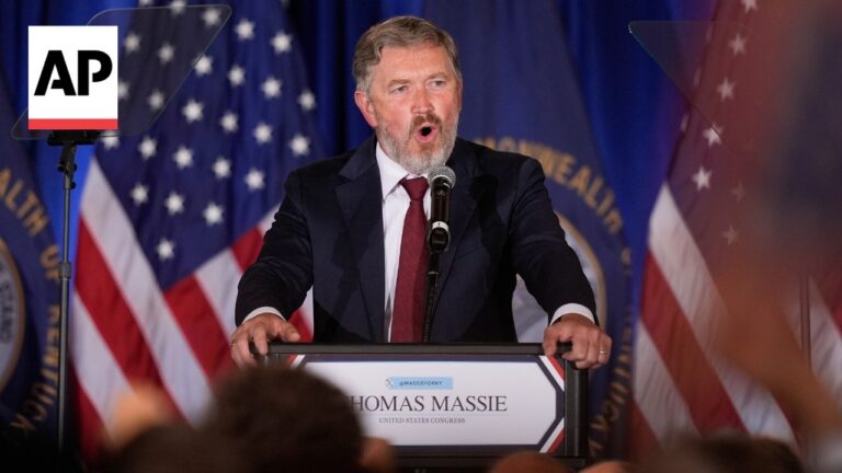 Thomas Massie giving a speech at a podium, with American flags in the background and an AP logo visible at left side.