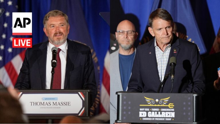 Two men speak at separate campaign podiums during a live AP event, with U.S. flag backdrop and audience in foreground.