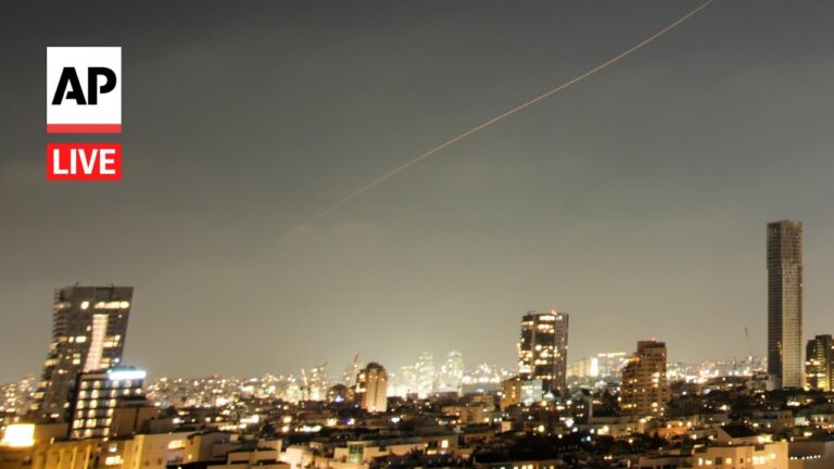 Nighttime city skyline with illuminated buildings and an AP Live watermark in the top-left corner.