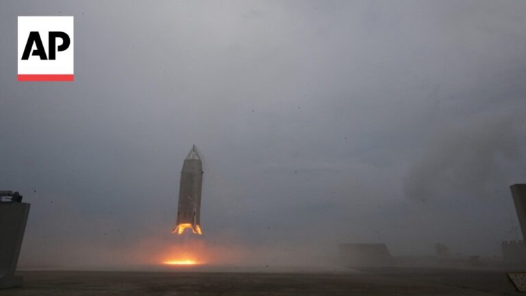 Rocket lifting off from a launch pad with bright orange flame and smoke, AP logo in the top-left corner.