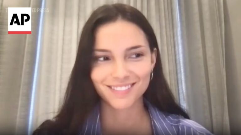 Smiling woman on a video call with the AP News logo in the top-left corner.