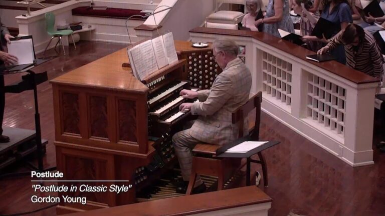 Organist Gordon Young seated at a wooden pipe organ, playing for a church audience; caption reads 'Postlude in Classic Style'.