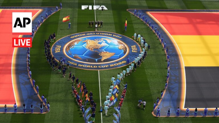 Aerial view of FIFA World Cup 2026 opening ceremony with players lined up around a central globe emblem on a football pitch, AP Live watermark visible on the left.