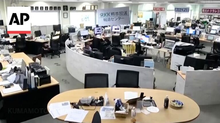 AP newsroom: crowded open-plan newsroom with desks, computers, and a curved white partition, AP logo visible in the corner.