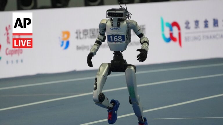 Humanoid robot racing on a track with a bib labeled 168 and AP Live logo nearby on the left edge of the image.