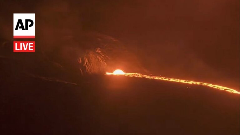 Nighttime lava flow glowing orange along a dark landscape, with AP Live logo in the top-left corner