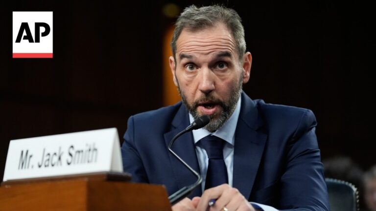 Man in a navy suit testifies at a hearing, speaking into a microphone; nameplate reads 'Mr. Jack Smith' with AP logo in the corner.